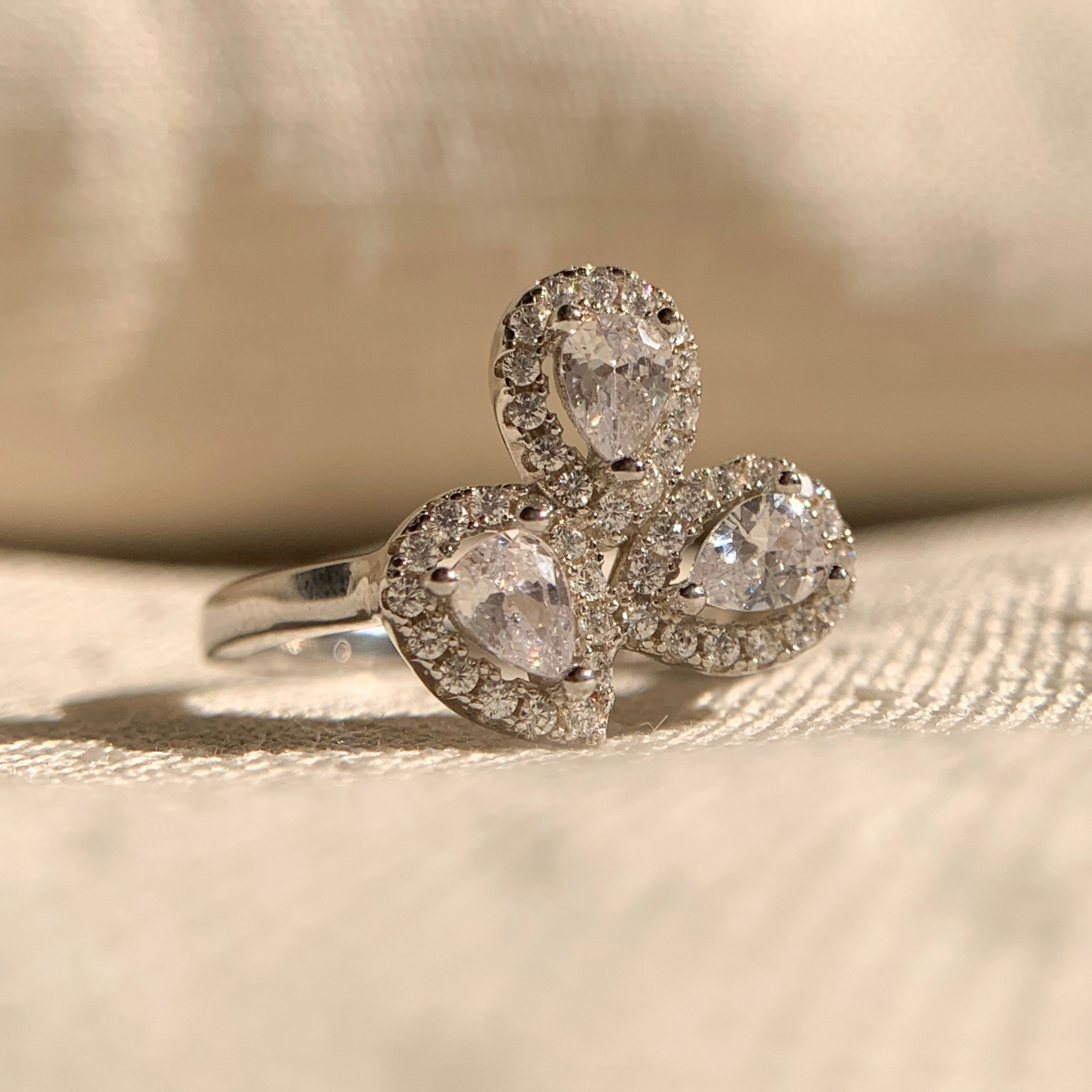 Three stone pear cut halo lab created diamond engagement ring in white gold